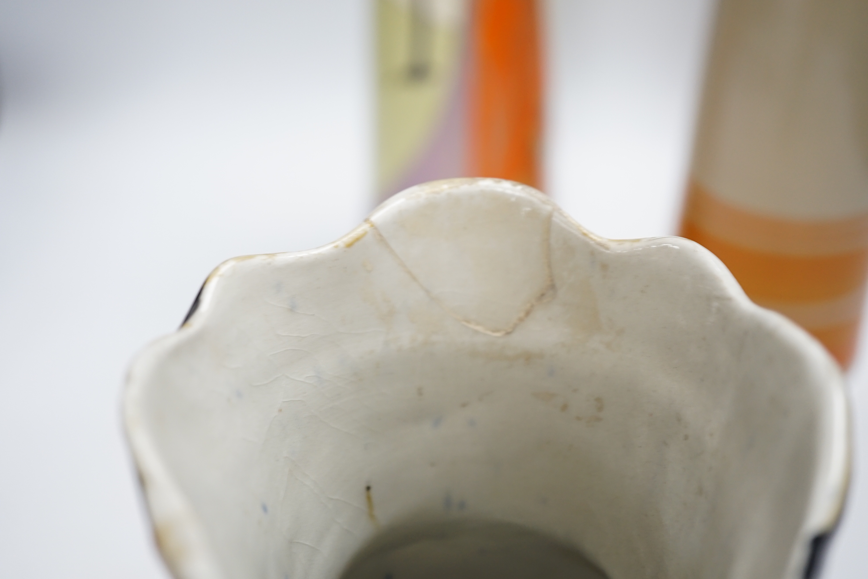A Bisto jug, two other jugs, a Toby jug and a Quimper saucer, tallest 39cm